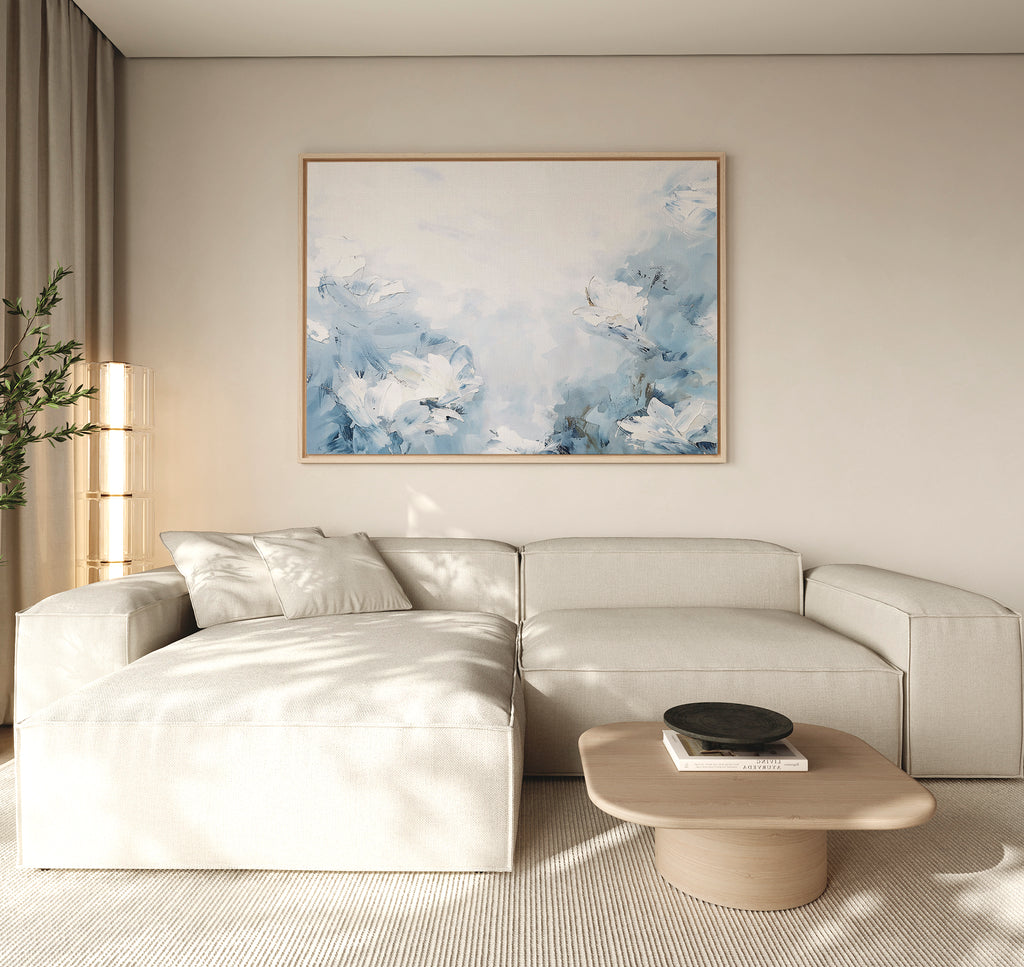 A modern living room featuring a light beige sectional sofa, the Spring Hues Canvas Art – Horizontal above, a low wooden coffee table with a black bowl, and sheer curtains—ideal for creating effortless living room decor.