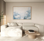 A modern living room featuring a light beige sectional sofa, the Spring Hues Canvas Art – Horizontal above, a low wooden coffee table with a black bowl, and sheer curtains—ideal for creating effortless living room decor.