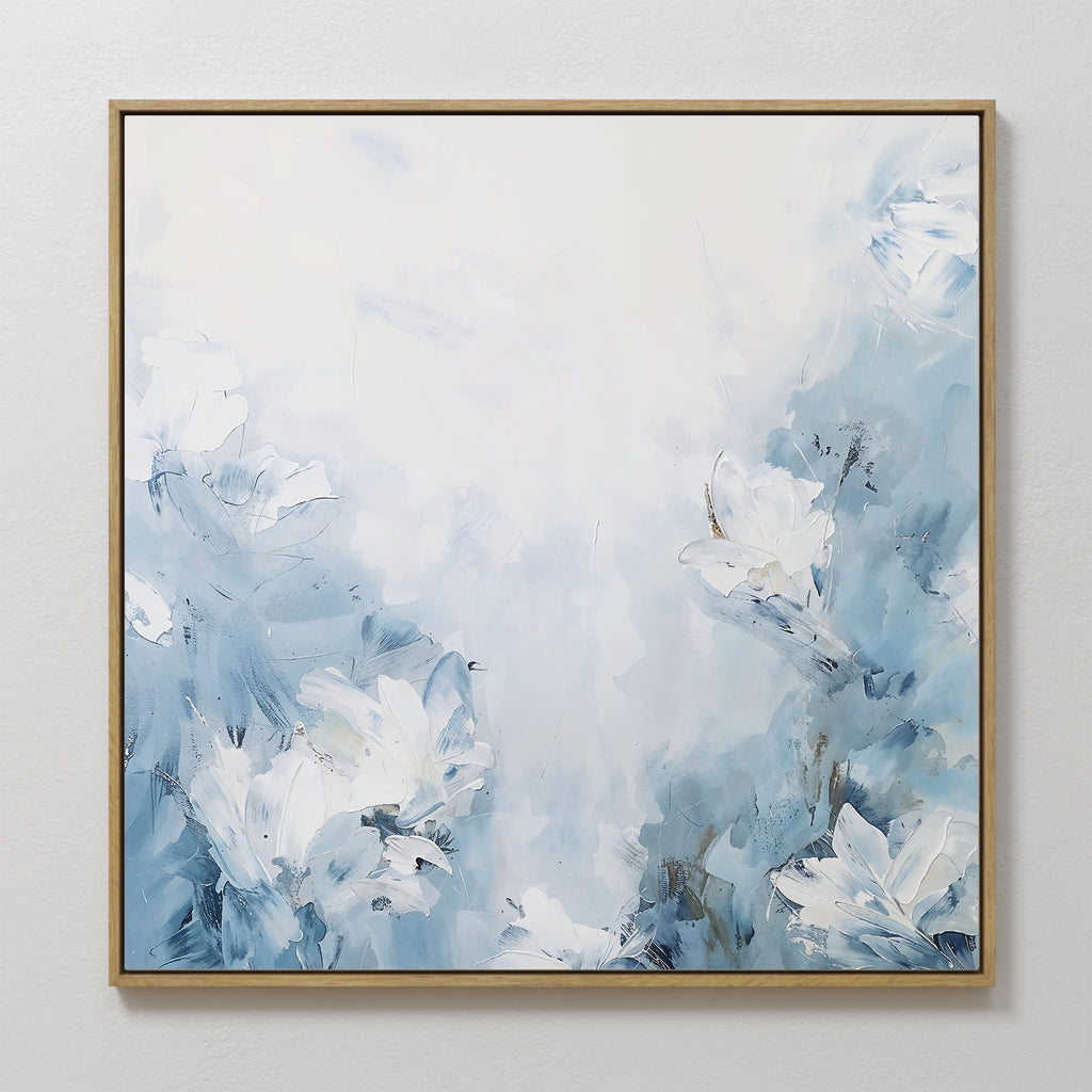 The Spring Hues Abstract Canvas Art showcases soft blue and white flowers with gentle brushstrokes, blending the floral design into a light background for a calm and tranquil atmosphere.