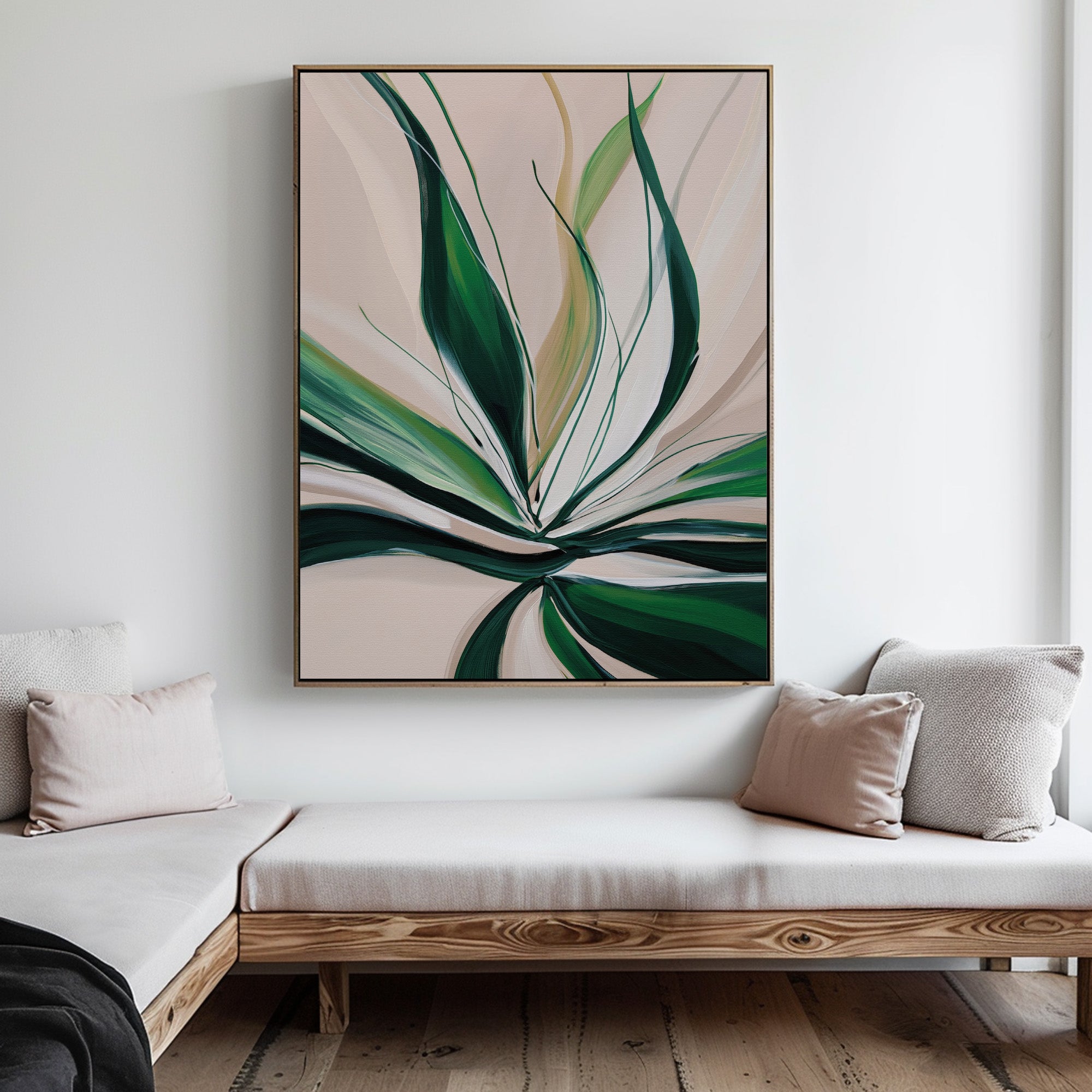 A modern living room with light wood furniture and neutral cushions features Springs Essence Abstract Canvas Art—a large painting of green leaves on a pale background—hanging on a white wall above a corner bench.