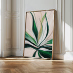 Springs Essence Abstract Canvas Art, a large minimalist piece with abstract green leaves on a light background, leans against a white paneled wall in a sunlit room with wooden parquet flooring.