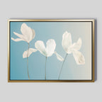 Stellar Flora Abstract Canvas Art features three delicate white flowers with long stems on a soft blue gradient background in a gold rectangular frame, making it perfect for elegant living room decor.
