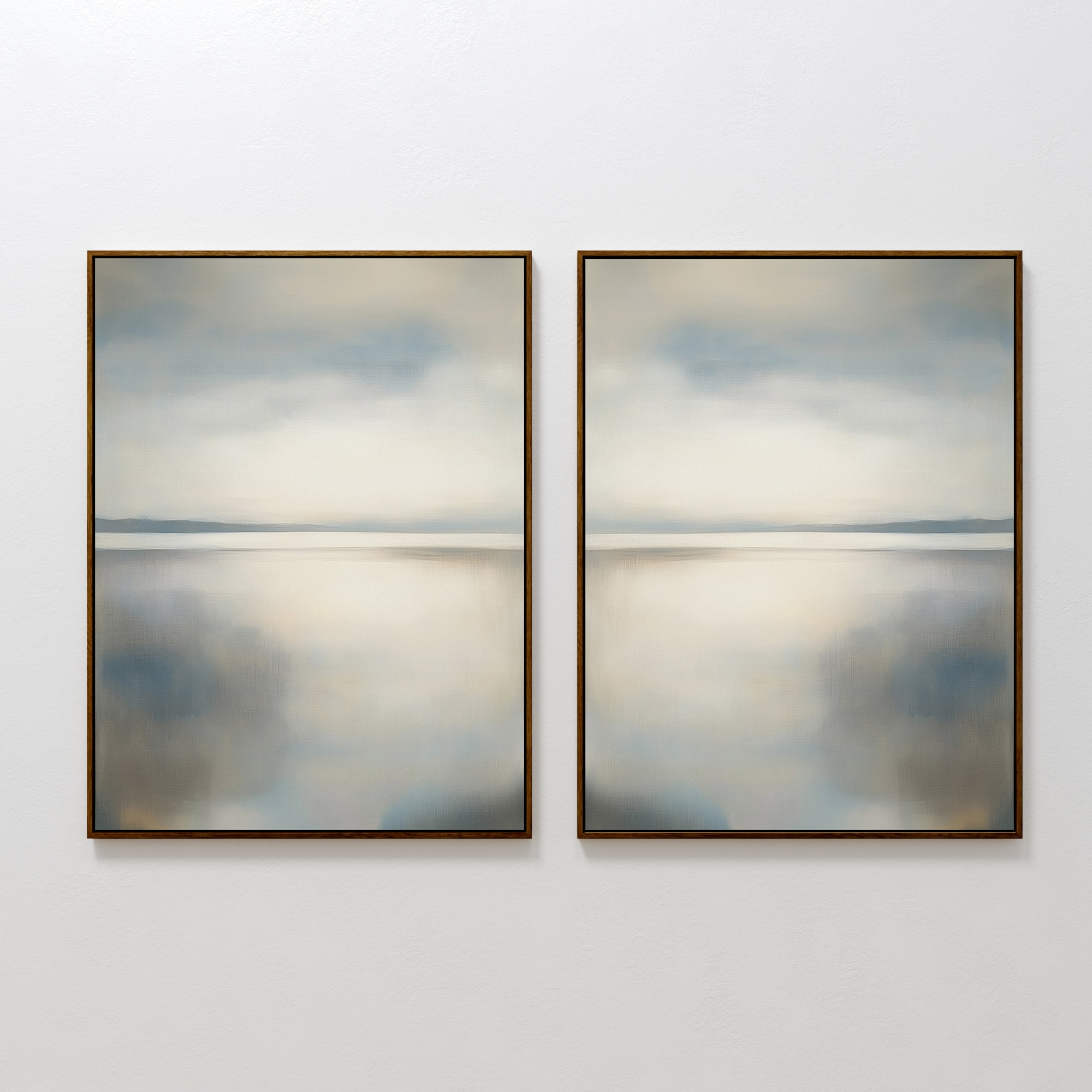 The Still Horizon Set of 2 features framed abstract prints, each portraying a calm shoreline in muted blue, gray, and beige—minimalist wall art that evokes tranquility for any room.