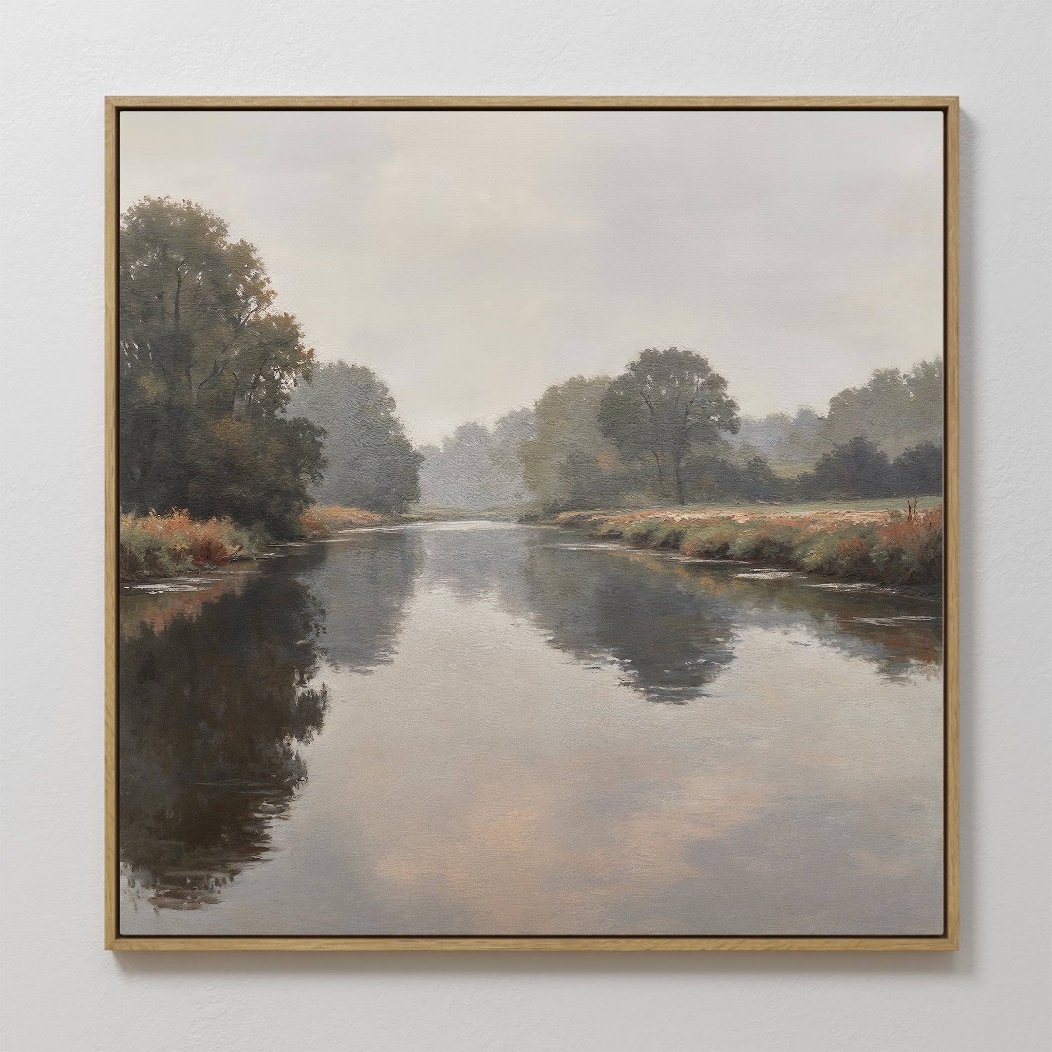 The Still Riverbank Canvas Art showcases a calm river with trees and grassy banks beneath a cloudy sky, offering soft reflections on the water—ideal minimalist wall art for creating tranquil bedroom décor.