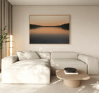 A modern living room with a light beige sectional sofa, low wooden coffee table, and a potted plant. The Still Waters Canvas Art – Horizontal above the sofa and neutral-toned minimal decor create a serene atmosphere.