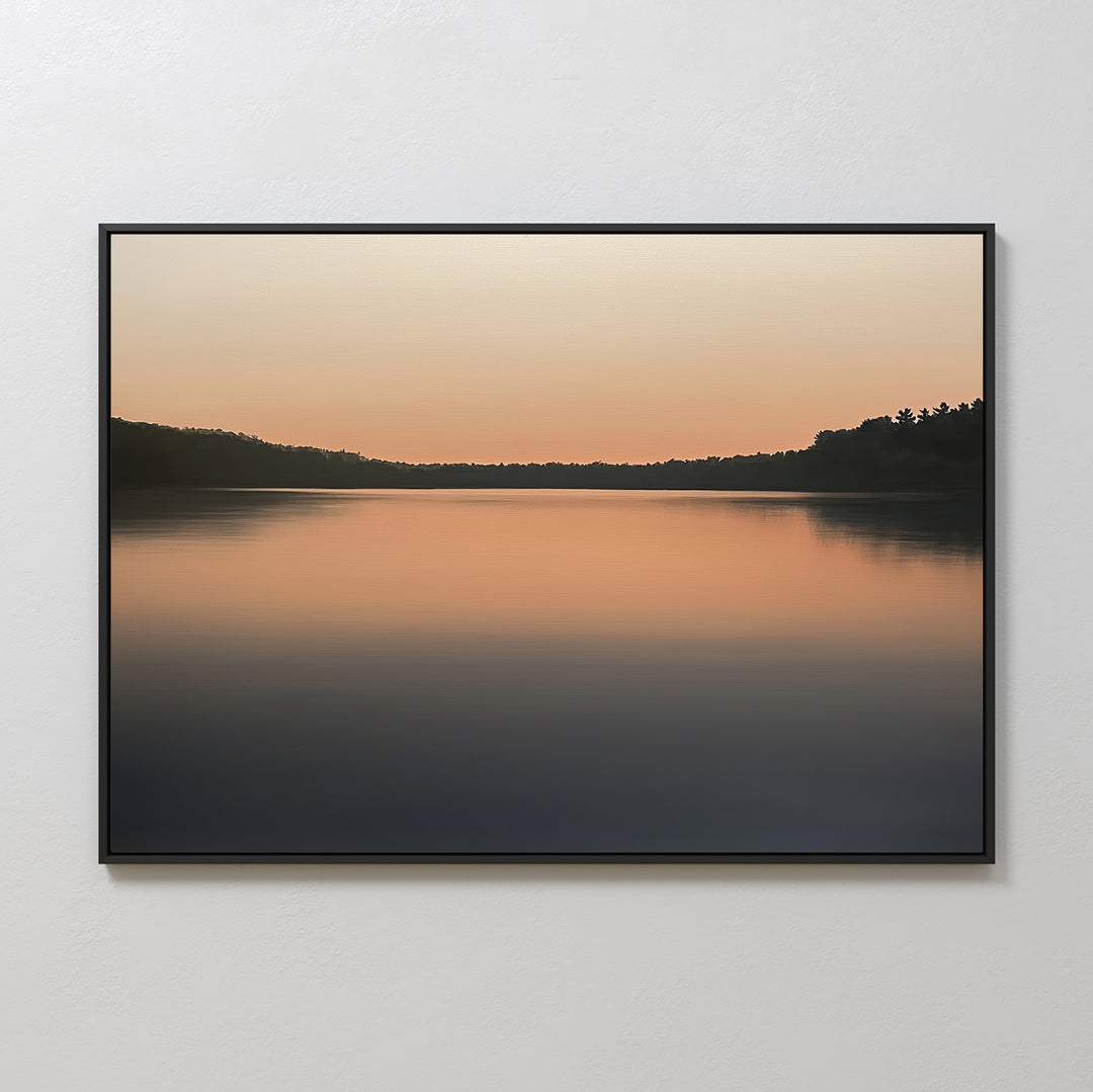 Still Waters Canvas Art – Horizontal: A tranquil canvas print of a calm lake at sunset, with soft orange and peach tones on still waters and dark tree silhouettes—perfect for serene bedroom décor.
