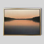 Still Waters Canvas Art – Horizontal features a serene lake at sunset with a soft gradient sky and silhouetted trees, making it perfect for tranquil bedroom decor or as elegant wall art to create a calming atmosphere.