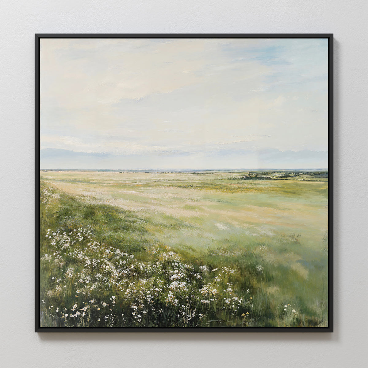 The Summer Meadow Canvas Art, featuring a sunlit meadow with green grass, wildflowers, and a bright sky, hangs on a white wall—ideal for bringing nature’s beauty into your living room decor.