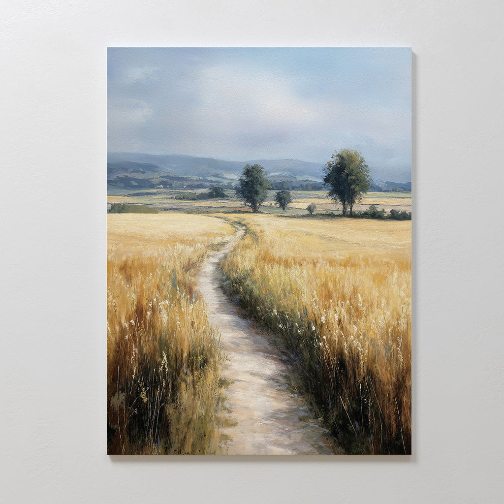 Sunlit Passage Canvas Art features a nature-inspired print of a winding dirt path through golden wheat fields, two trees, and distant hills beneath soft clouds—ideal minimalist wall art for creating a tranquil, welcoming space.