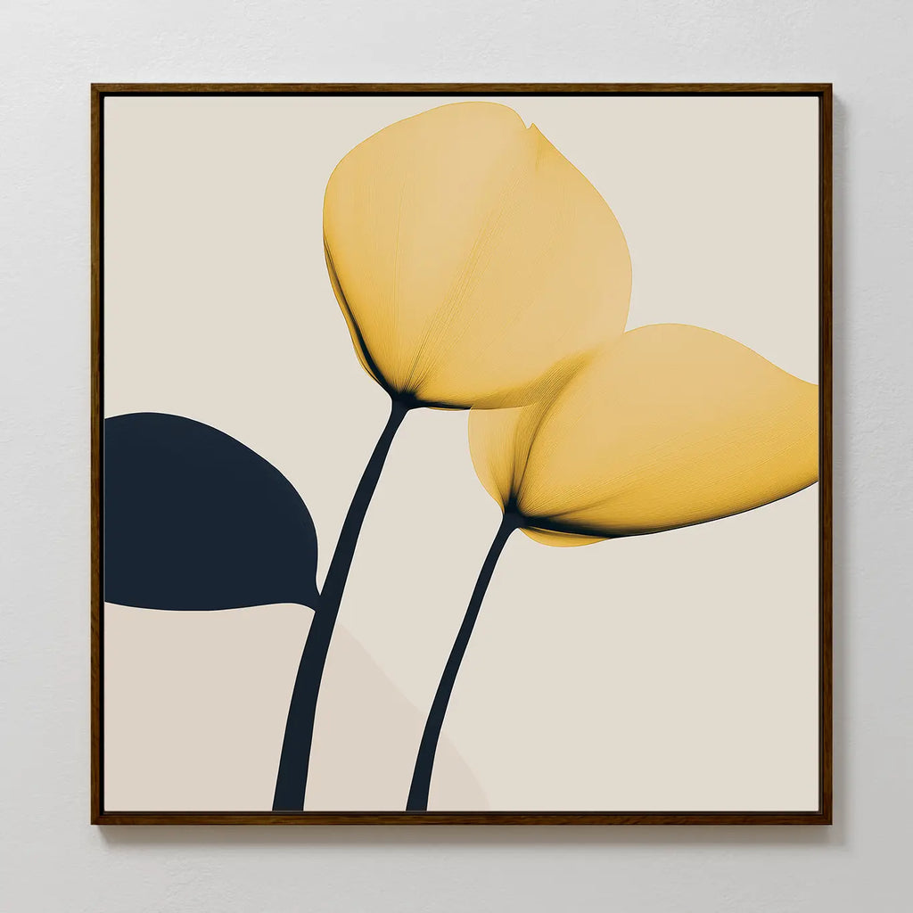 The Sunny Flora Canvas Art features two yellow blooms with black stems and a dark leaf on a light beige background, framed in a slim brown frame—a simple, modern accent perfect for contemporary living rooms.