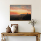 A wooden table with two vases, a decorative basket, and a small wooden frame stands against a light wall, above which hangs the Sunset Reflection Canvas Art depicting a colorful sunset over rolling hills.