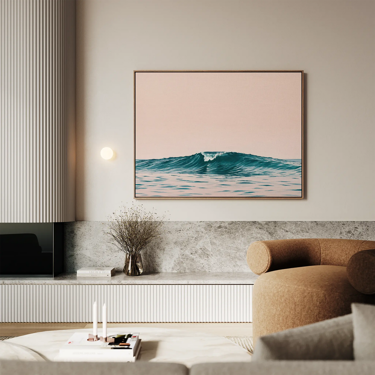 A modern living room with a beige armchair, marble surfaces, and the Sunset Wave Canvas Art—featuring pastel waves and a pale pink sky—hung above a minimalist shelf accented with decorative items.