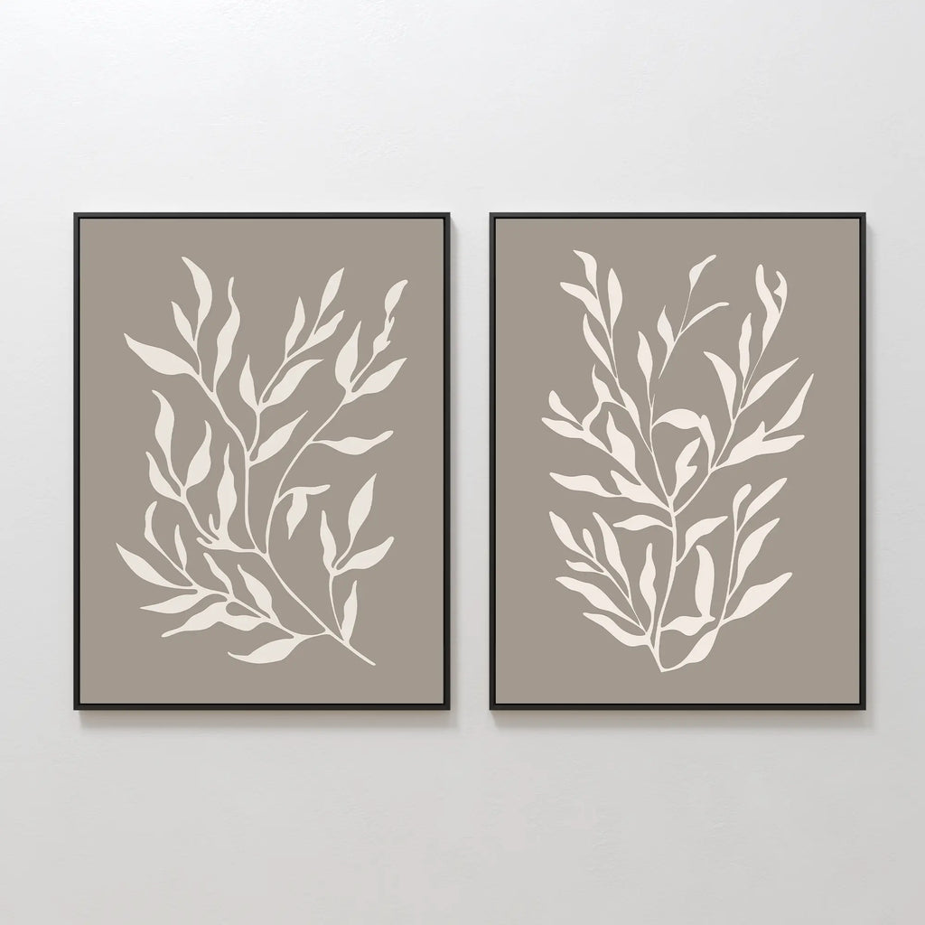 The Taupe Botanical Set of 2 features framed prints with white leafy branches on a light taupe background, ideal as contemporary wall art when hung side by side in any modern space.