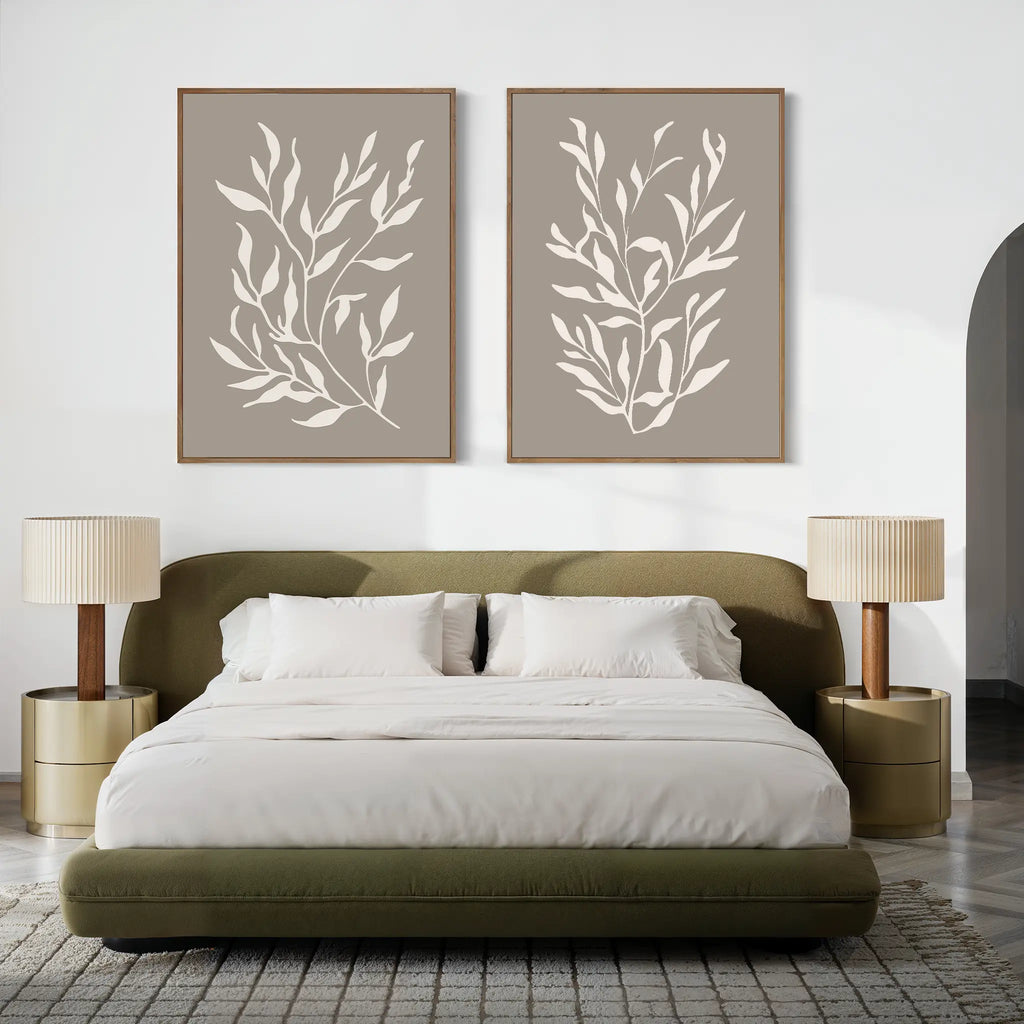 A modern bedroom featuring a green upholstered bed, white bedding, beige nightstands with matching lamps, and the Taupe Botanical Set of 2 prints above the bed—perfect for contemporary interior enthusiasts.