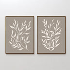 The Taupe Botanical Set of 2 features framed minimalist prints with white leafy branch silhouettes on a taupe background, perfect for contemporary interiors.