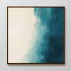 Teal Tide Canvas Art in a brown frame features a gradient from off-white to deep blue with cloud-like transitions and watercolor texture, adding a modern, striking focal point to any white wall.