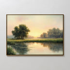 The Journey Canvas Art features a framed rustic landscape with trees, tall grass, and a calm river reflecting soft sunrise or sunset light beneath a pastel sky—a tranquil touch of natural beauty for countryside-inspired decor.