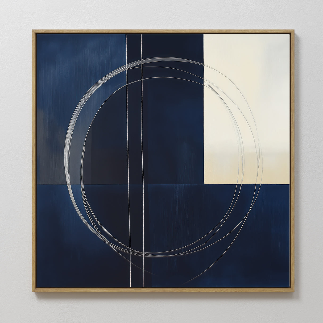 The Orbit Canvas Art showcases a navy blue and cream color block design with thin, overlapping white circular and straight lines, all in a light wood frame—perfect for adding minimalist style to modern home decor.