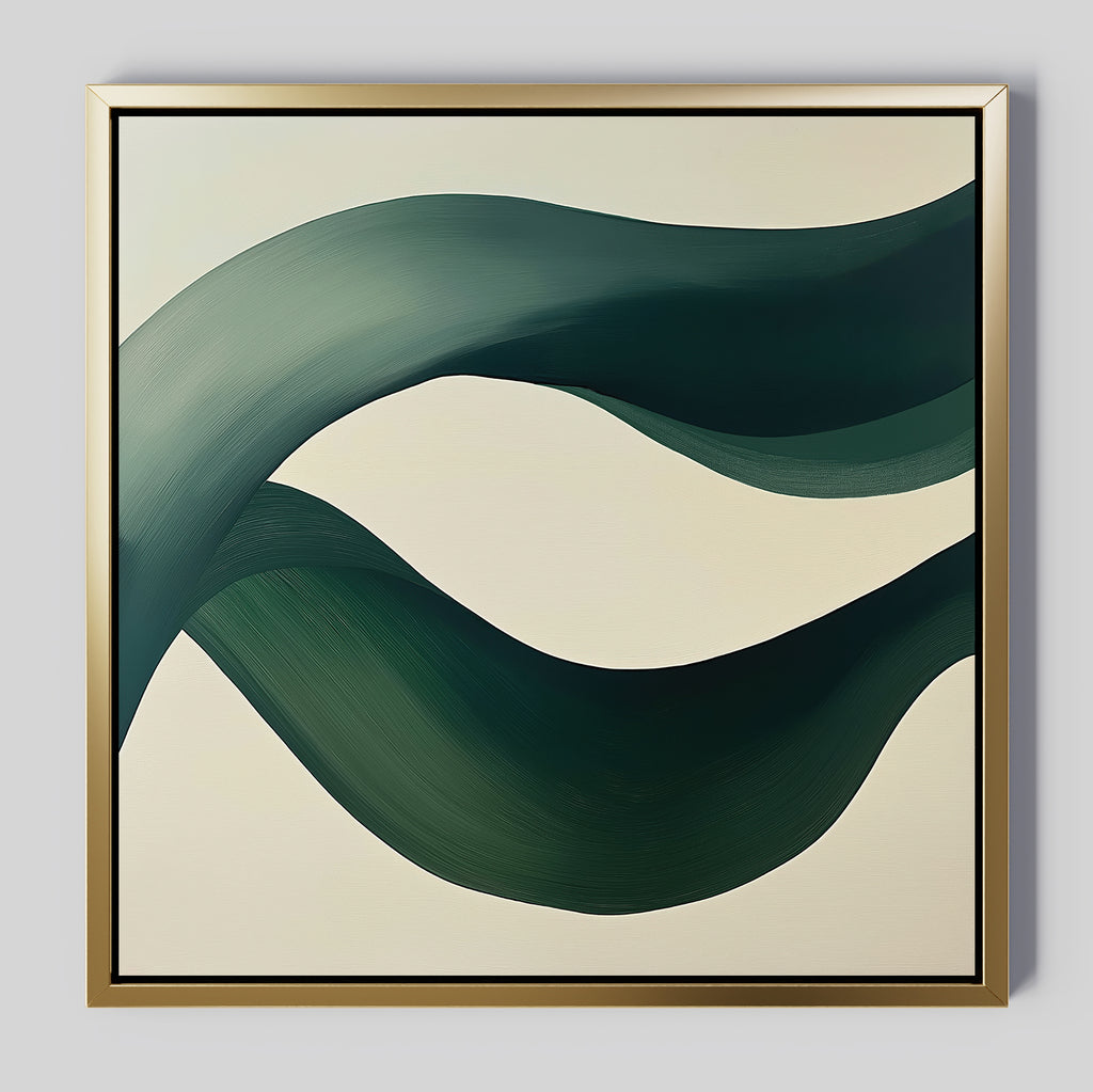 Tidal Grace Canvas Art features two bold, dark green ribbon-like curves on a cream background, framed in slim gold—a striking piece of modern abstract wall art ideal for elevating your living room decor.