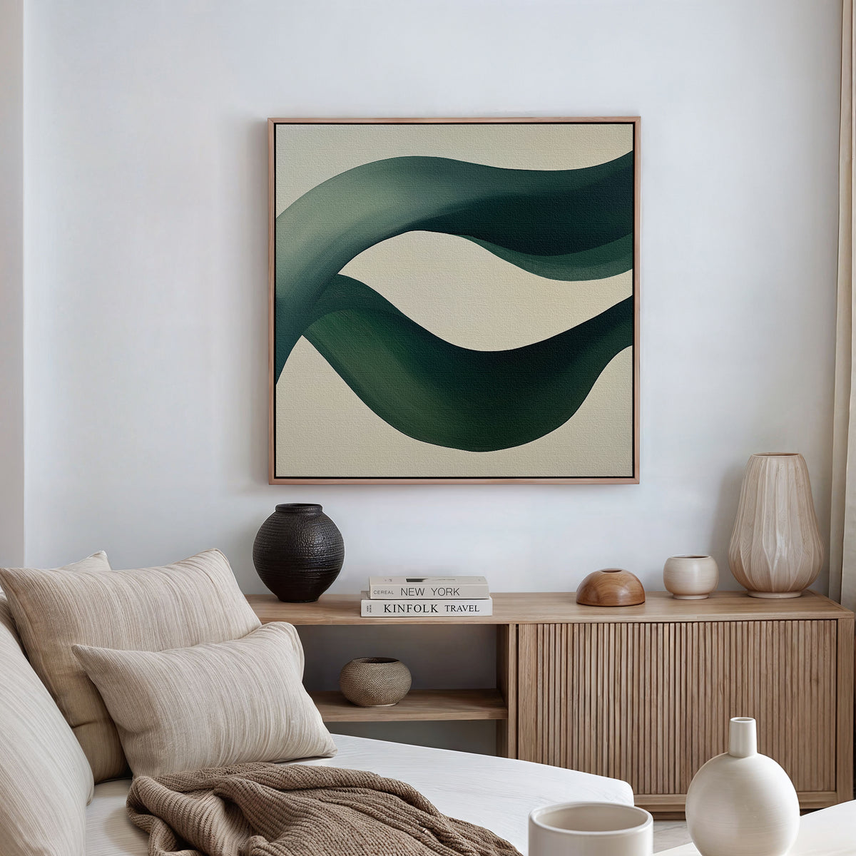 A modern living room with neutral tones features a beige sofa with cushions, a wooden sideboard with vases and books, and the Tidal Grace Canvas Art adding a vibrant touch to the space.