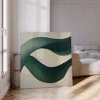 The Tidal Grace Canvas Art, with sweeping green and blue curves, is displayed against a wall in a bright modern living room featuring parquet floors and a white sofa.