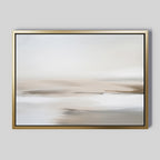 The Tranquil Shifts Canvas Art – Horizontal features soft, blurred neutral tones on a light gray backdrop. Framed in gold, this abstract painting brings a serene minimalist landscape look to any living room decor.