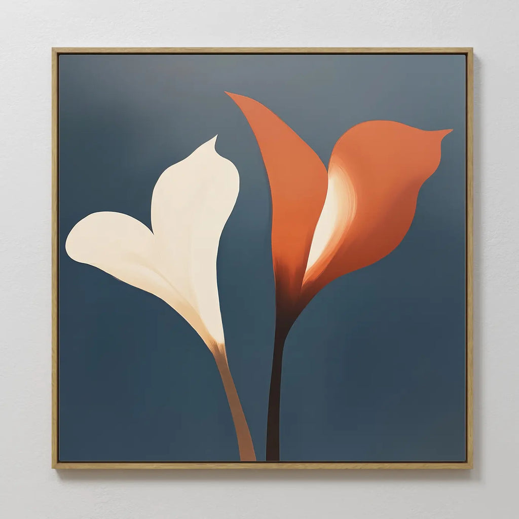 Twin Blooms Canvas Art showcases two calla lilies—one white, one orange—on a blue backdrop with brown stems. Inspired by Nordic Park, this botanical print comes framed in a slim, light wood frame.