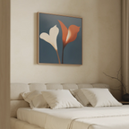 A minimalistic bedroom features a beige bed with four white pillows. Above, the Twin Blooms Canvas Art from Nordic Park displays two calla lilies—one white, one red—set against a dark blue background for striking wall decor.