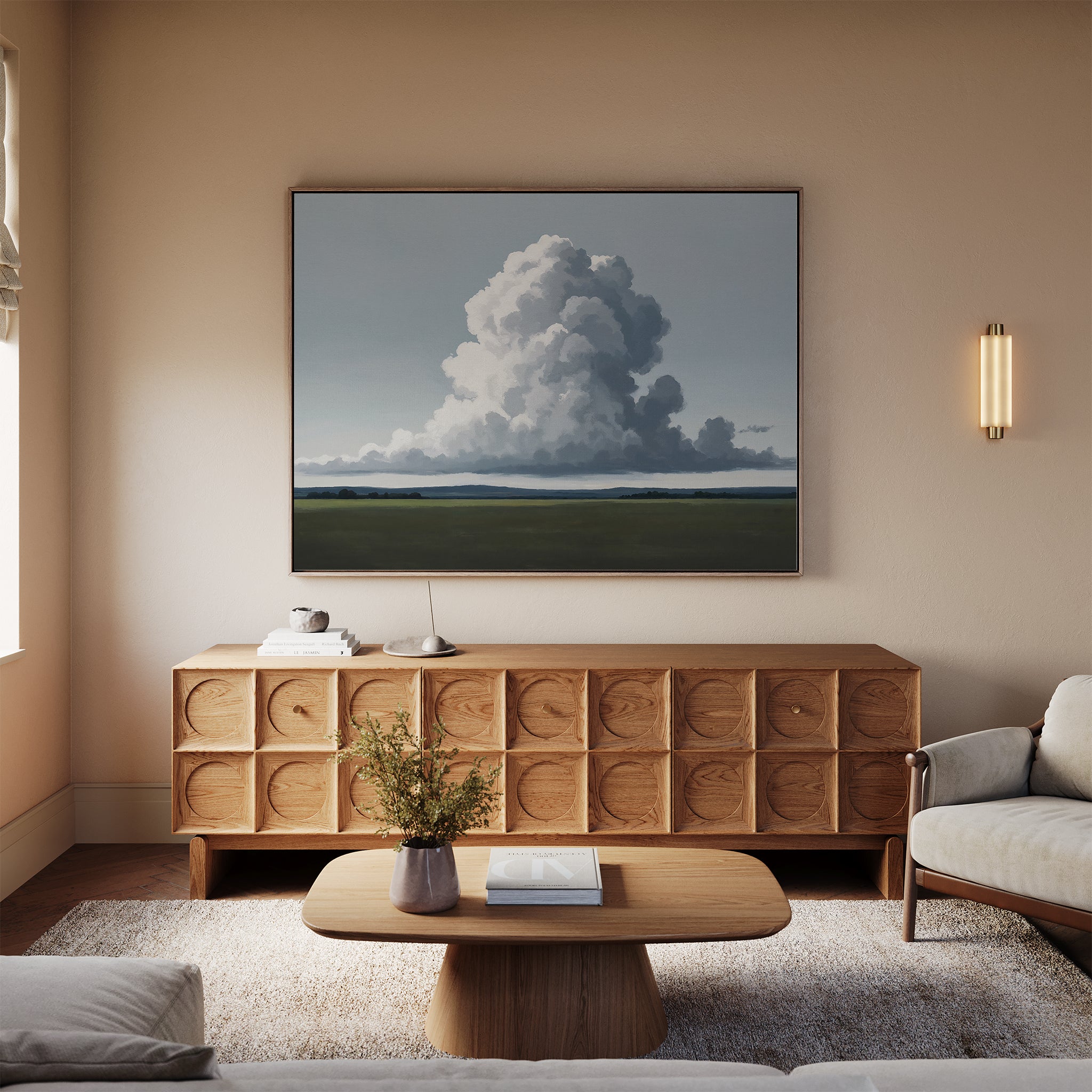 A cozy living room with minimalist decor—Uplifted Sky Canvas Art above a wooden sideboard, a modern coffee table with flowers and books, and a light sofa—all in neutral tones.