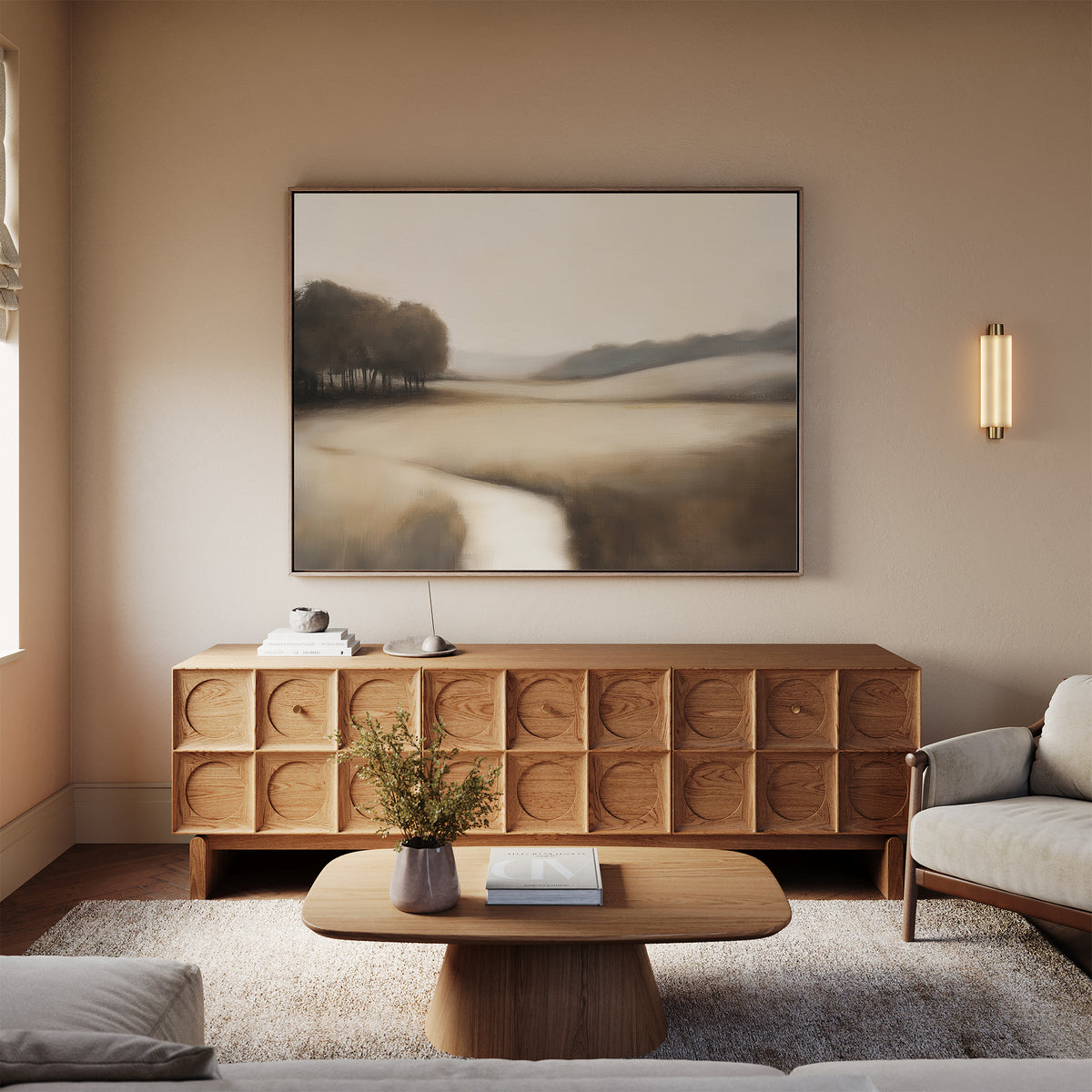 A cozy living room with beige walls features the Vintage Horizon Canvas Art – Horizontal above a wooden sideboard with circular patterns, a small coffee table, a vase of flowers, and a light gray sofa bathed in natural light.