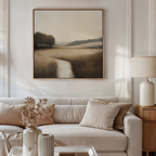 A neutral-toned living room with a beige sofa, matching cushions, a side table, and dried flowers. Above the sofa hangs the Vintage Horizon Canvas Art, adding a minimalist touch and enhancing the space’s decor.