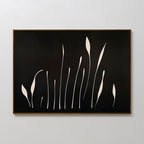 Botanical Silhouettes Abstract Canvas Art showcases elongated white floral silhouettes on a solid black background, resembling tall grass or stems, and is framed with a thin brown border.