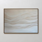 Sandy Hues Abstract Canvas Art features soft white and beige waves on a pale background in a thin dark frame. This minimalist piece brings calm and gentle movement, making it ideal for modern living room decor.