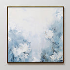 Spring Hues Abstract Canvas Art is a square painting featuring soft blue and white tones with abstract flowers. Loose brushstroke petals float on a hazy background, all elegantly framed in a thin brown border.