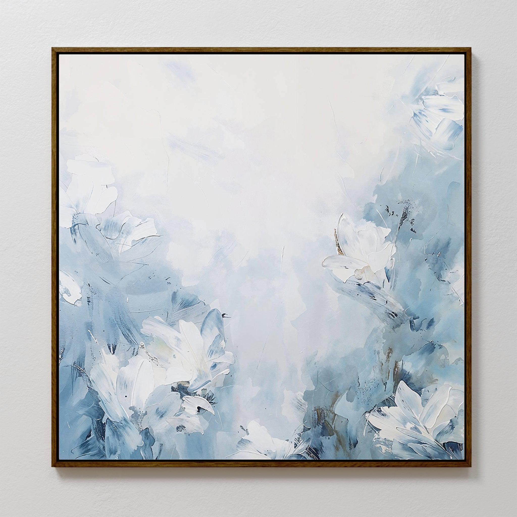 Spring Hues Abstract Canvas Art is a square painting featuring soft blue and white tones with abstract flowers. Loose brushstroke petals float on a hazy background, all elegantly framed in a thin brown border.