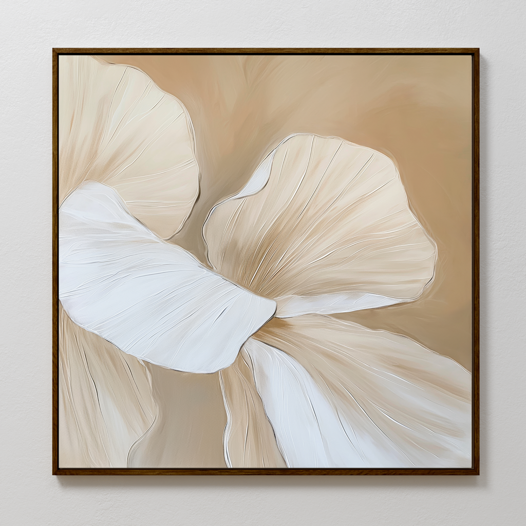 Floral Whisper Abstract Canvas Art features two large, overlapping cream and beige petal shapes outlined in fine white on a soft tan background, framed with a slim dark border and displayed on a light textured wall.
