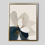 Whispering Petals Canvas Art - Vertical features a framed abstract flower with translucent black, white, beige, and taupe petals on a light background in a gold frame—ideal minimalist wall art for living room decor.
