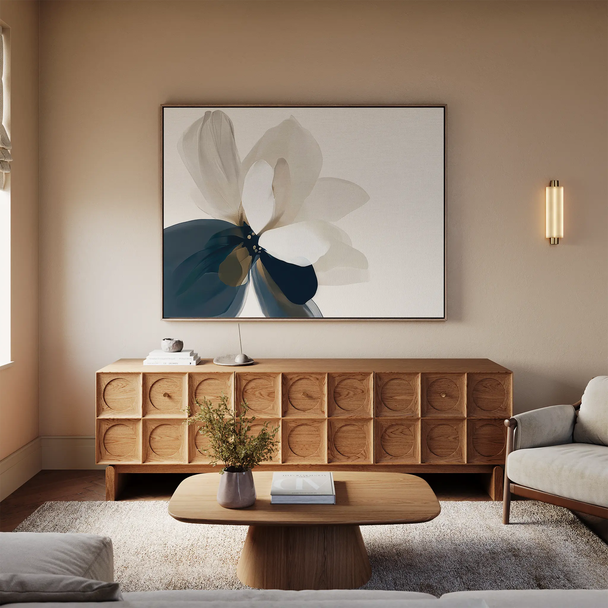A modern living room with light walls, a wooden sideboard, the Whispering Petals Canvas Art - Horizontal, a round coffee table with a vase, beige sofa, rug, and wall sconce—perfect for elevating your living room decor.