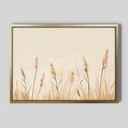 Whispering Reeds Canvas Art features beige and brown wheat stalks on a light background, framed in gold—an elegant piece to enhance your living room decor with modern, minimalist style.