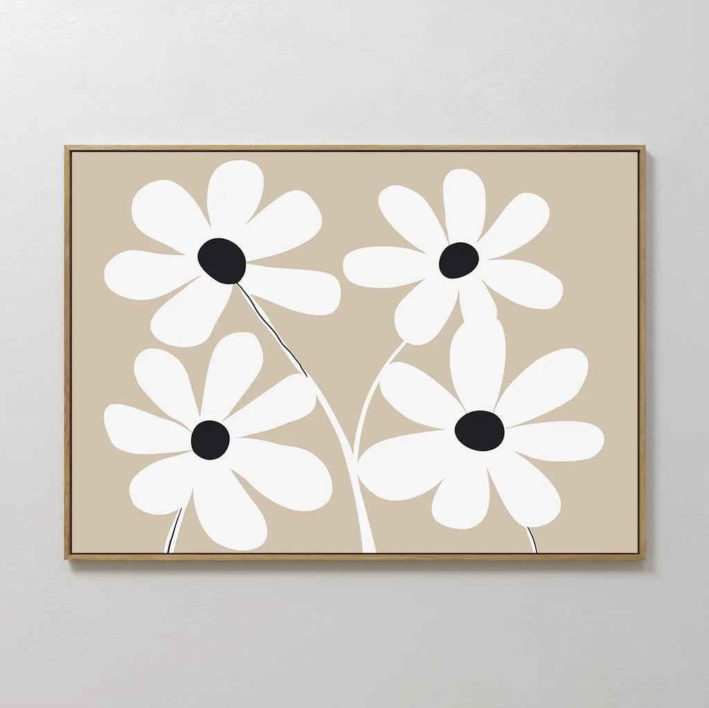 White Blooms Canvas Art: A framed modern botanical print featuring four white flowers with black centers and stems on a beige background, displayed against a light wall.