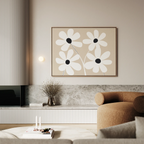 A modern living room in neutral tones features the White Blooms Canvas Art—an abstract daisy piece—paired with a beige curved sofa, marble-topped low shelf, dried flowers in a vase, and soft ambient lighting.