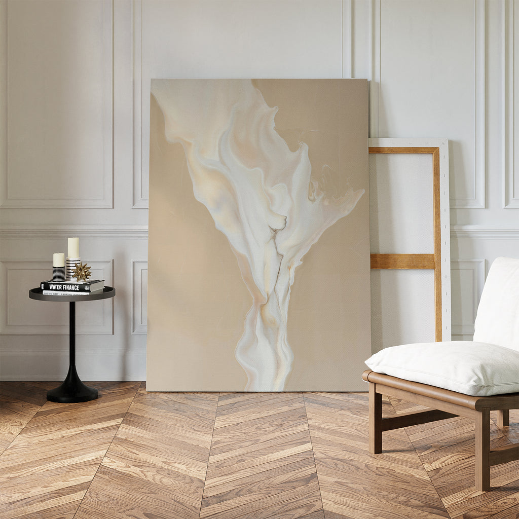 A minimalist living space with herringbone wood floors features the White Flame Abstract Canvas Art leaning against the wall, a black side table with candles, an empty frame, and a white cushioned chair.
