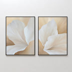 The White Flora Set of 2 features framed prints of abstract white flora on soft beige backgrounds, displayed side by side to highlight delicate shapes and a serene, minimalistic Nordic Park-inspired botanical wall art style.