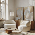 A modern living room features the White Flora Set of 2 rounded chairs, a low wooden coffee table, a floor lamp, and botanical wall art on a wooden sideboard beneath tall windows.