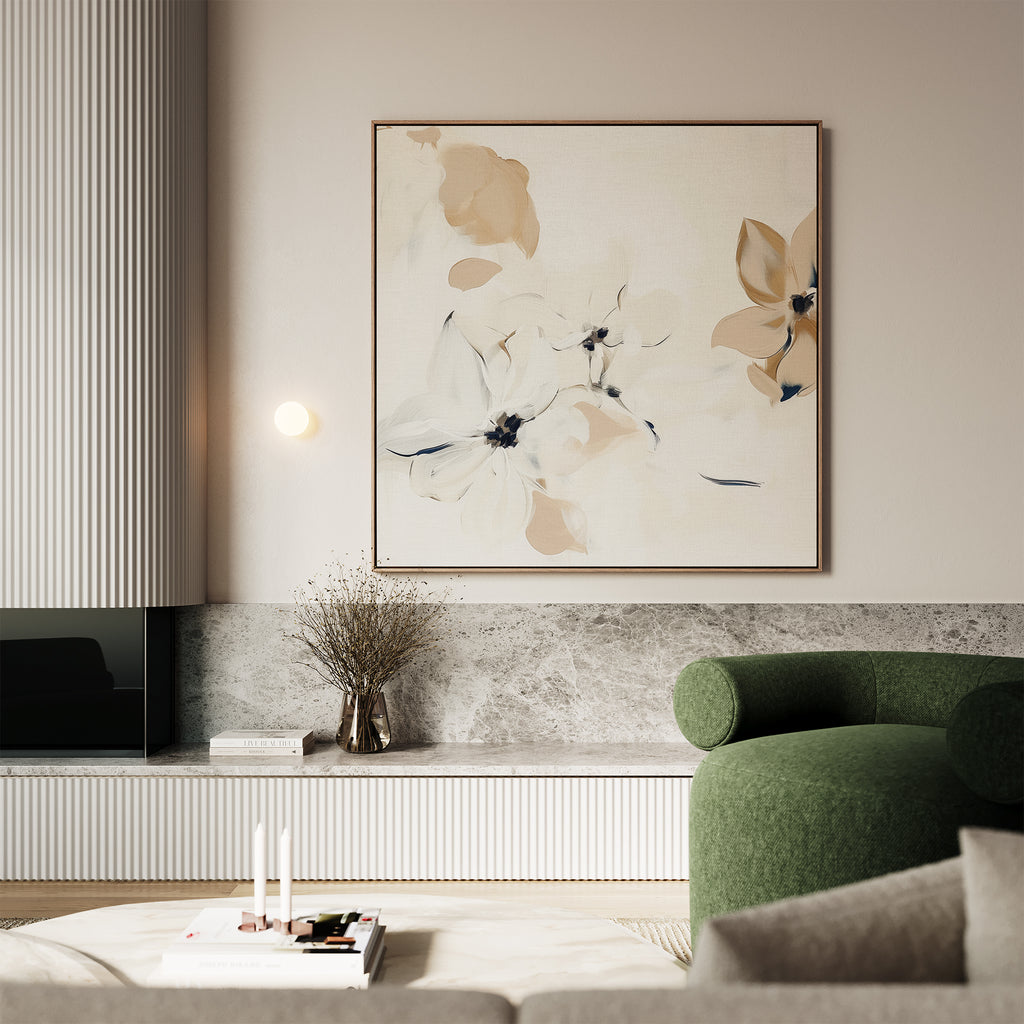 A modern living room features a green curved sofa, marble surfaces, a round coffee table with candles and books, a vase with dried branches, and the White Whispers Canvas Art in neutral tones to complete the stylish decor.