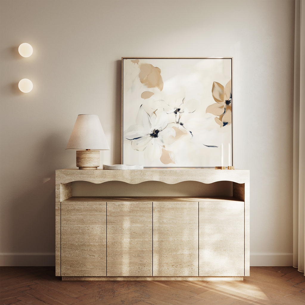 A minimalist console table with a scalloped edge displays a lamp, two candles, and the White Whispers Canvas Art. Two round wall lights and gentle natural light create a warm, serene vibe—ideal for thoughtful living room decor.