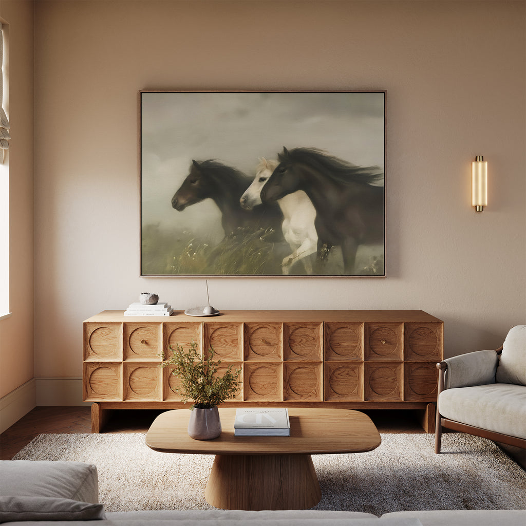 A cozy living room with a wooden coffee table, sofa, and sideboard features the Wild Current Canvas Art above it and is softly lit by a wall sconce—perfect for inspiring your living room decor.