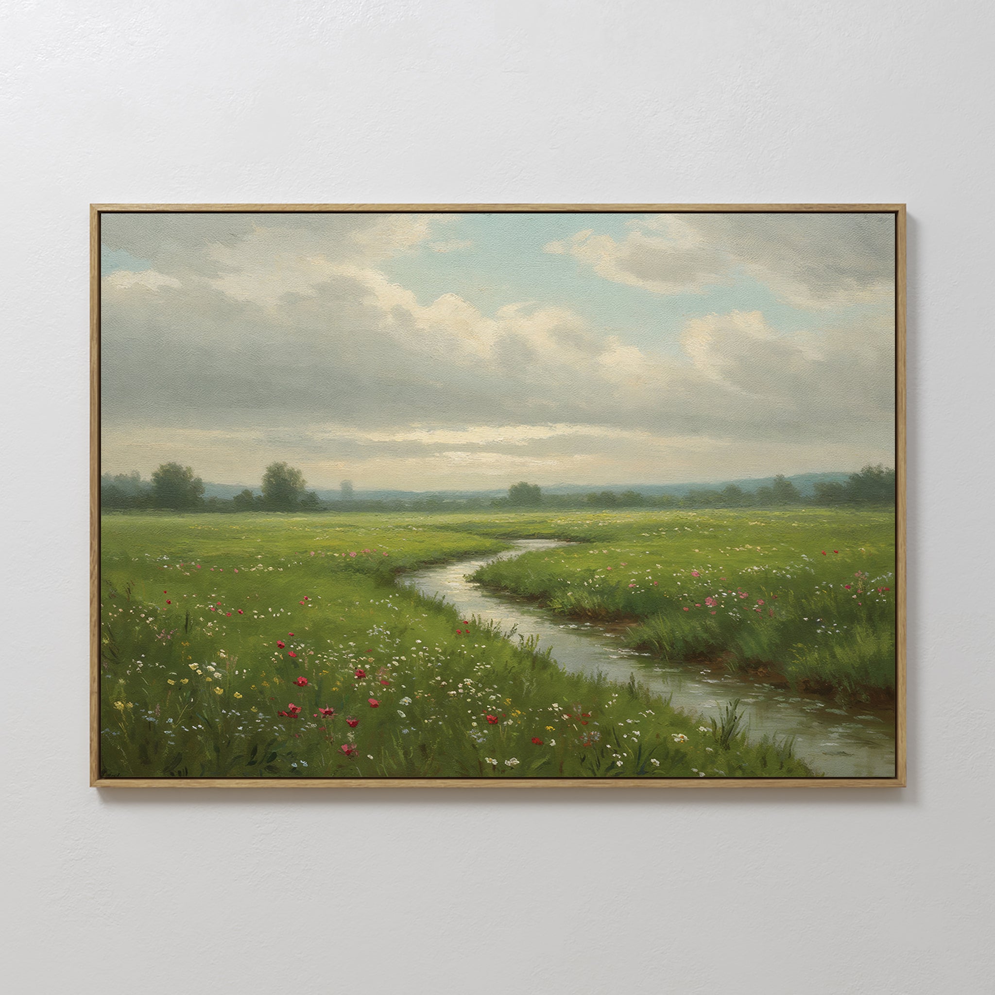 The Winding Stream Canvas Art features a minimalist green landscape of a grassy meadow with wildflowers and a winding stream beneath a cloudy sky, perfect as framed wall decor for any space.