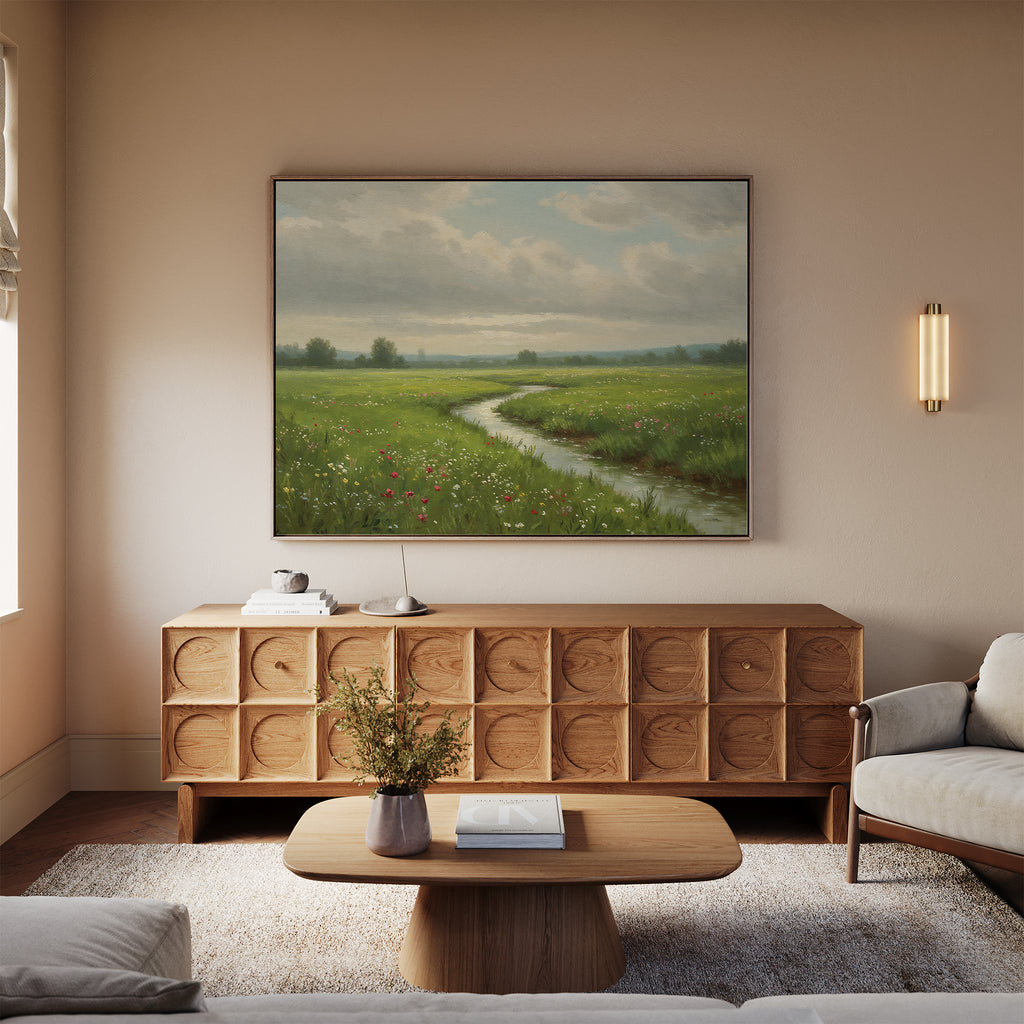 A neutral-toned living room featuring a textured wooden sideboard, the Winding Stream Canvas Art above it, a modern coffee table, two beige sofas, and a wall sconce for an inviting look.