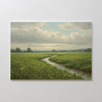 The Winding Stream Canvas Art features a green landscape with a grassy field, wildflowers, and a winding stream under cloudy skies. Minimalist trees appear in the distance, bringing serenity to any space when mounted on light-colored walls.